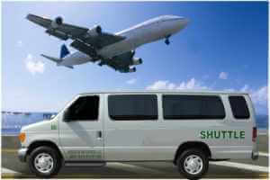 An airplane and a white shuttle service car.